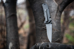 Stainless Steel Folding Knife Pierced Into Wooden Stump, lifestyle photo