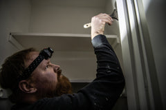 Painter using LED Headlamp to Illuminate Desired Area, lifestyle photo