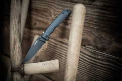 Stainless Steel Blade Folding Knife Resting Open Against Wood Wall, lifestyle photo